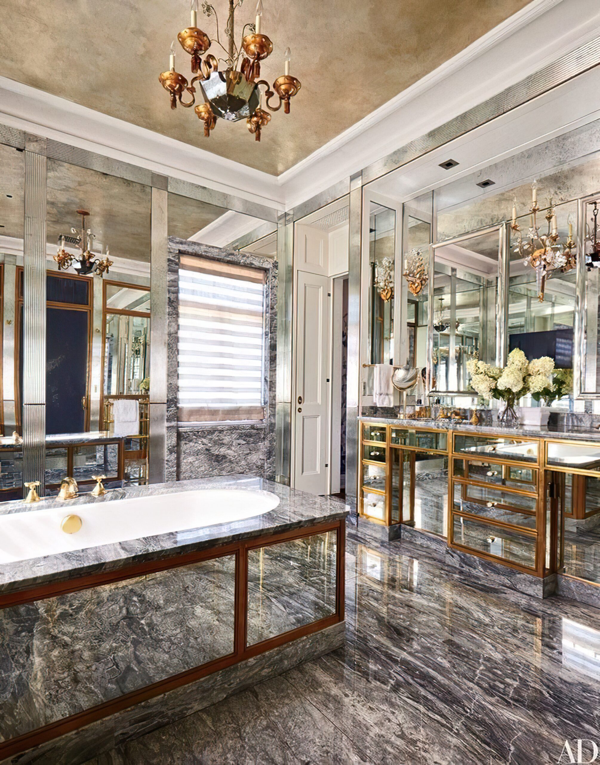 bathroom-with-large-mirror-sink-with-chandelier-it
